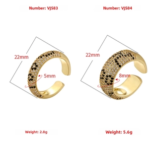 Detail view of gold leopard pattern rings with black and white cubic zirconia stones