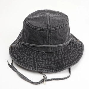 Washed denim bucket hat in charcoal black with wide brim and adjustable chin strap