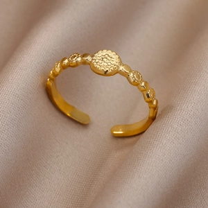 Macro detail of 18k gold plated adjustable ring with hammer texture disc and beaded band