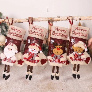 Set of four festive Christmas stockings with Santa, Snowman, Reindeer and Bear on a wooden rack
