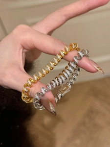 Detailed macro view of 18K gold plated twisted spiral bracelet with dense zircon pavé and AG925 stamp
