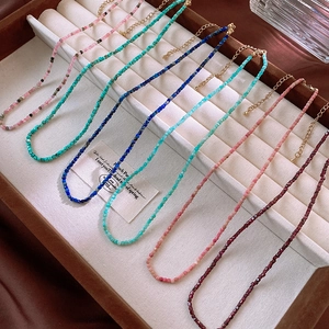 Detail of colorful faceted bead necklaces with gold lobster clasp on jewelry display