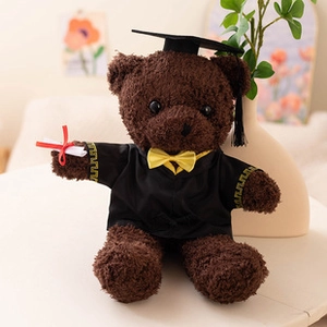 Close-up of a dark brown graduation teddy bear with academic cap and diploma scroll