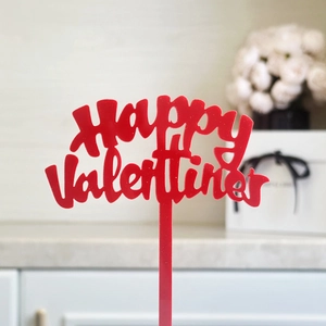 Red acrylic Happy Valentines cake topper with hollow lettering and sleek design