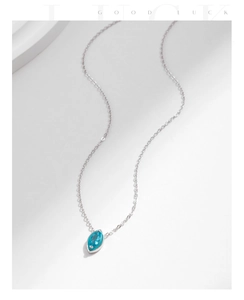 Macro shot of s925 silver necklace with marquise-cut mint green gemstone pendant
