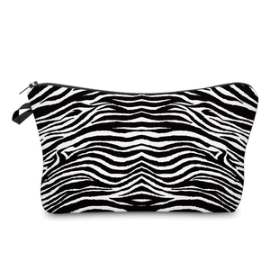 Detail of a zebra print makeup bag featuring a black zipper and small side carry handle