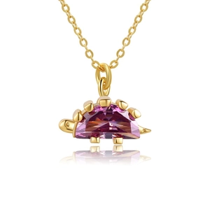 Detail of 18K gold-plated dinosaur pendant featuring a faceted purple gemstone back