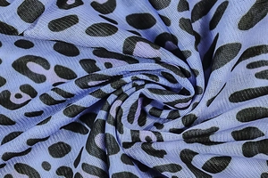 Macro detail of breathable blue leopard print mesh fabric with subtle sheer texture