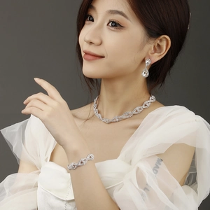 Close-up of bridal silver rhinestone jewelry set including necklace, earrings and bracelet