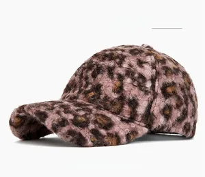 Close-up of pink leopard print plush baseball cap showing soft faux fur texture detail