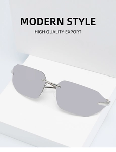 Detail view of rimless sunglasses with silver metal temples on a white geometric stand