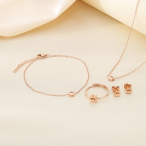 Rose gold jewelry set with cute paw print design including necklace, bracelet, and ring