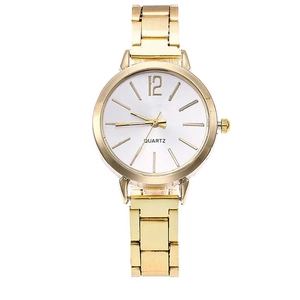 Detail of a minimalist women's quartz watch with a gold metal chain strap and white dial
