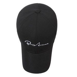 Classic black cotton baseball cap with white embroidered signature in a top-down view