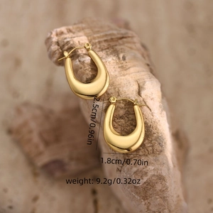 Polished 18K gold U-shaped stainless steel earrings on natural stone background