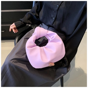 Detail of lavender crescent bag showing the signature knotted handle and soft leather texture