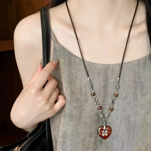 Ceramic beaded heart pendant necklace with silver clover motif on brown cord