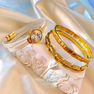 Luxury gold serpent scale bracelet set with crystals on elegant white silk background