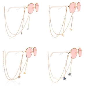 Golden metal eyewear chains with butterfly beads and evil eye charms on sunglasses