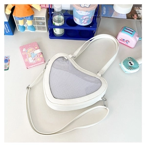 Detailed view of heart-shaped JK uniform ita bag with clear window and white PU leather texture