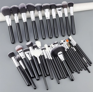 Macro shot of 40-piece professional makeup brush set with black handles and soft bristles