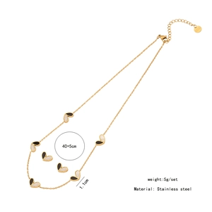 Detailed view of bicolor heart pendant necklace set with size specifications and material