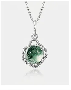 Close-up of green moss agate pendant in organic S925 silver frame on a thin chain