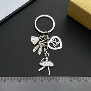 Elegant silver ballet keychain with dress, shoes, heart charms and ruler for size scale