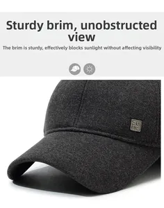 Detail of grey wool baseball cap showing firm brim and metallic logo emblem