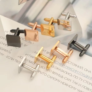 Artistic display of square cufflinks in black, rose gold, gold, and silver finishes