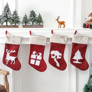 Four-piece Christmas stocking set featuring reindeer and pine tree designs on fireplace