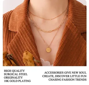 Detail of 18K gold plated titanium steel triple layer necklace with engraved coin pendant