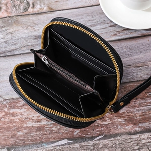 Detailed interior of black semi-circular wallet showing card slots and golden zipper