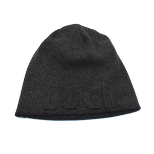 Close-up of charcoal grey knit beanie with raised 3D LUCKY letter embroidery detail
