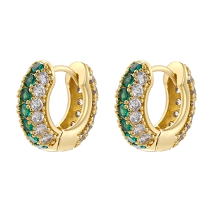 Detailed close-up of 18K gold huggie earrings with emerald green and white micro-pave crystals