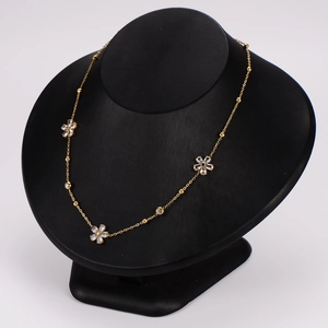 Elegant gold stainless steel flower necklace set featuring sparkling crystal pendants