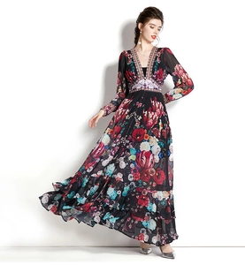Close-up of V-neckline floral print maxi dress with intricate geometric waist detailing
