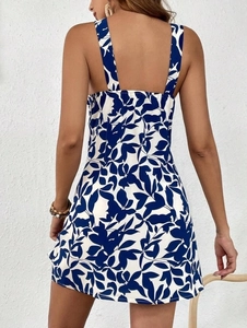 Detail of the backless halter design and blue leaf print on the summer mini dress