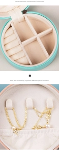 Detail of round mint green PU jewelry box with rings slots and necklace hooks