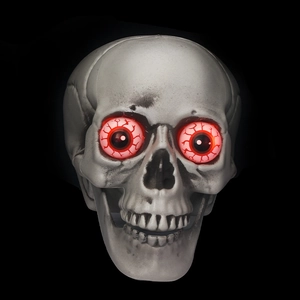 Close-up of Halloween skull with glowing red eyes on a dark background for spooky decor