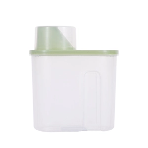 Clear plastic food storage container with a green measuring cup lid on a white background