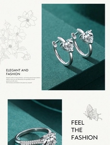 Macro shot of silver heart-shaped zircon ring and matching earrings set on green surface