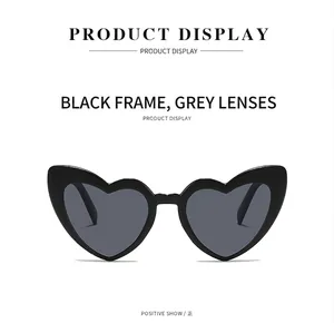 Front view of stylish heart-shaped sunglasses with black frames and grey lenses