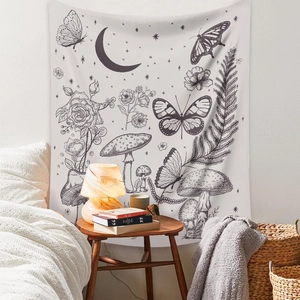 Detail of bohemian black and white tapestry with moon, moth, and stars in bedroom setting
