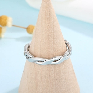 Silver twisted rope stackable ring made of stainless steel on a wooden display stand
