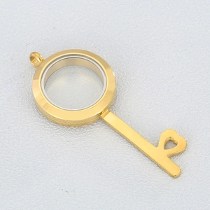 Detail of 25mm gold key-shaped locket pendant with glass photo frame and hollow heart