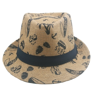 Detailed texture of woven straw fedora hat featuring summer surf prints and black band
