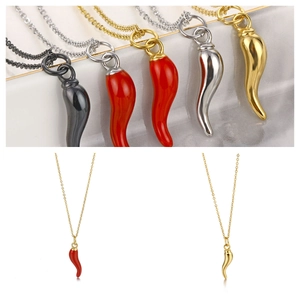 Detailed macro view of colorful chili pendant necklaces in red, black, gold and silver