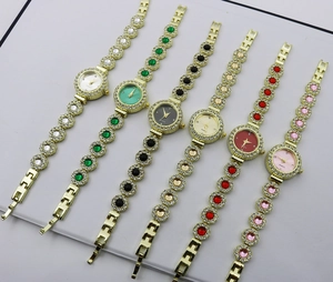 Close-up of gold quartz watches with colorful gemstone bracelets and crystal accents