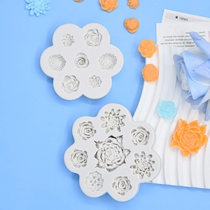 White silicone rose flower fondant molds set with colorful resin crafts on blue background